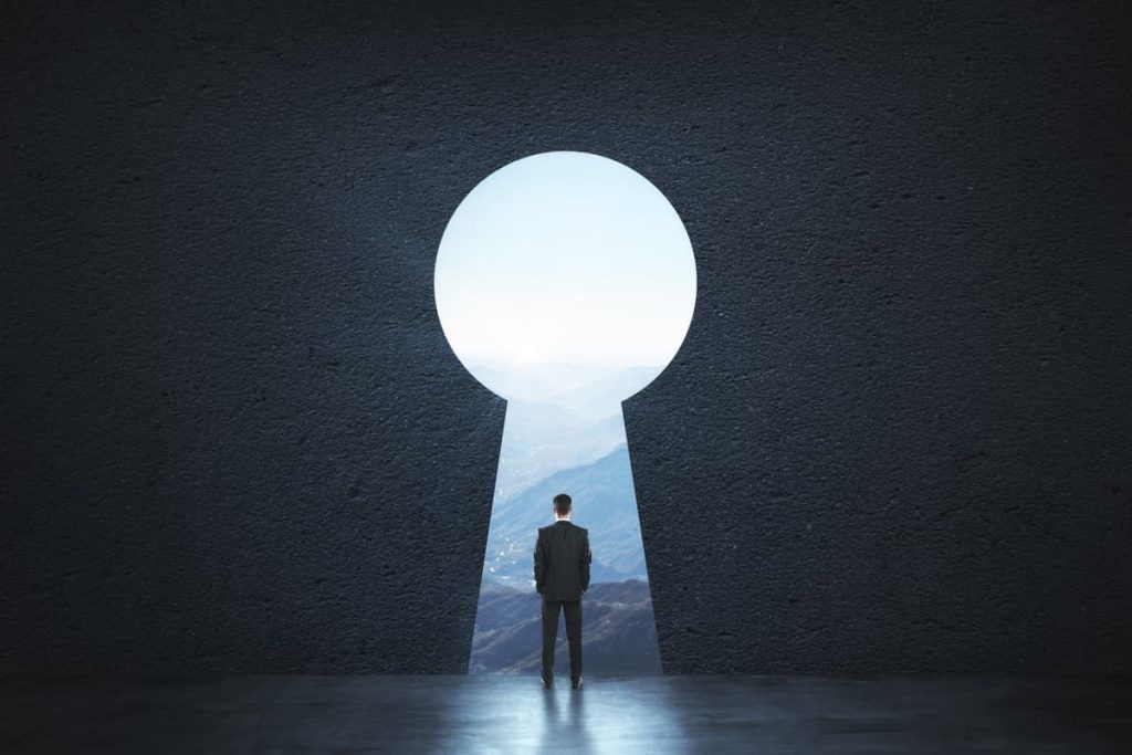 A man standing in front of a keyhole.