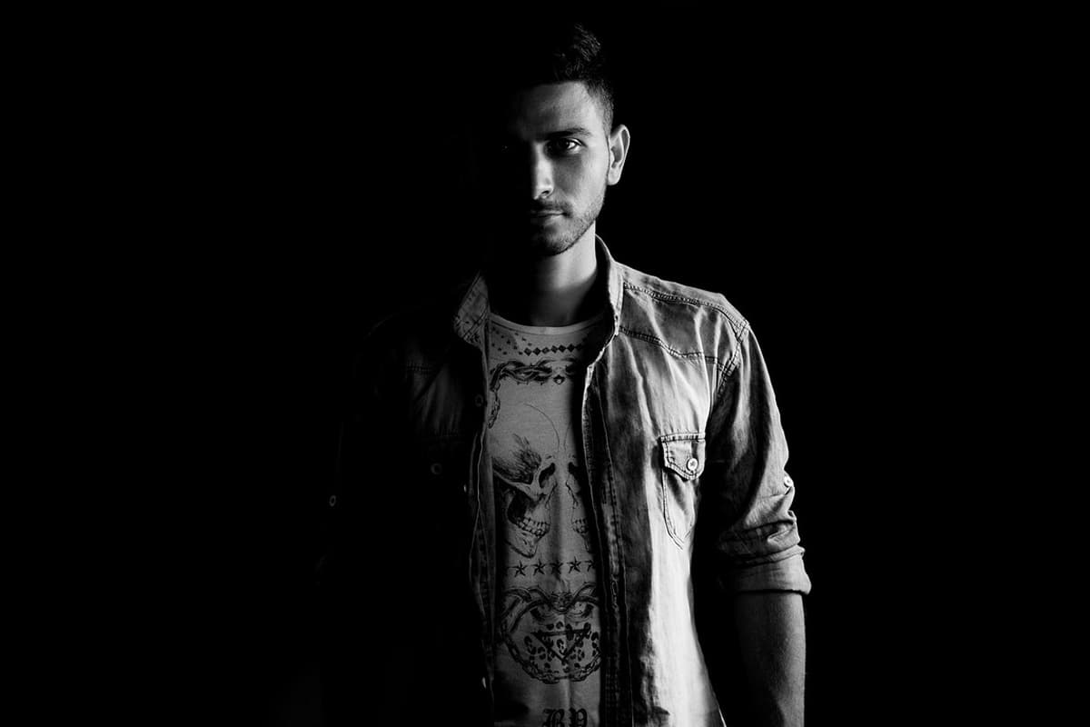 A man standing in a dark room.