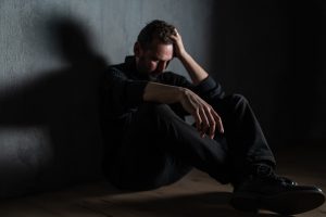 A young man in distress while alone.